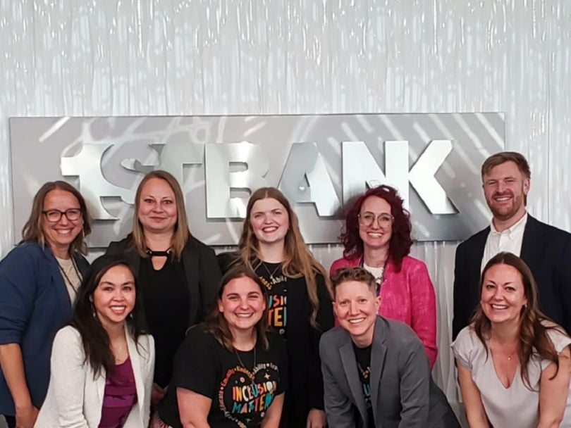 Members of FirstBank’s Neurodiversity & Abilities Employee Resource Group (ERG) pose for a group photo in the company’s office